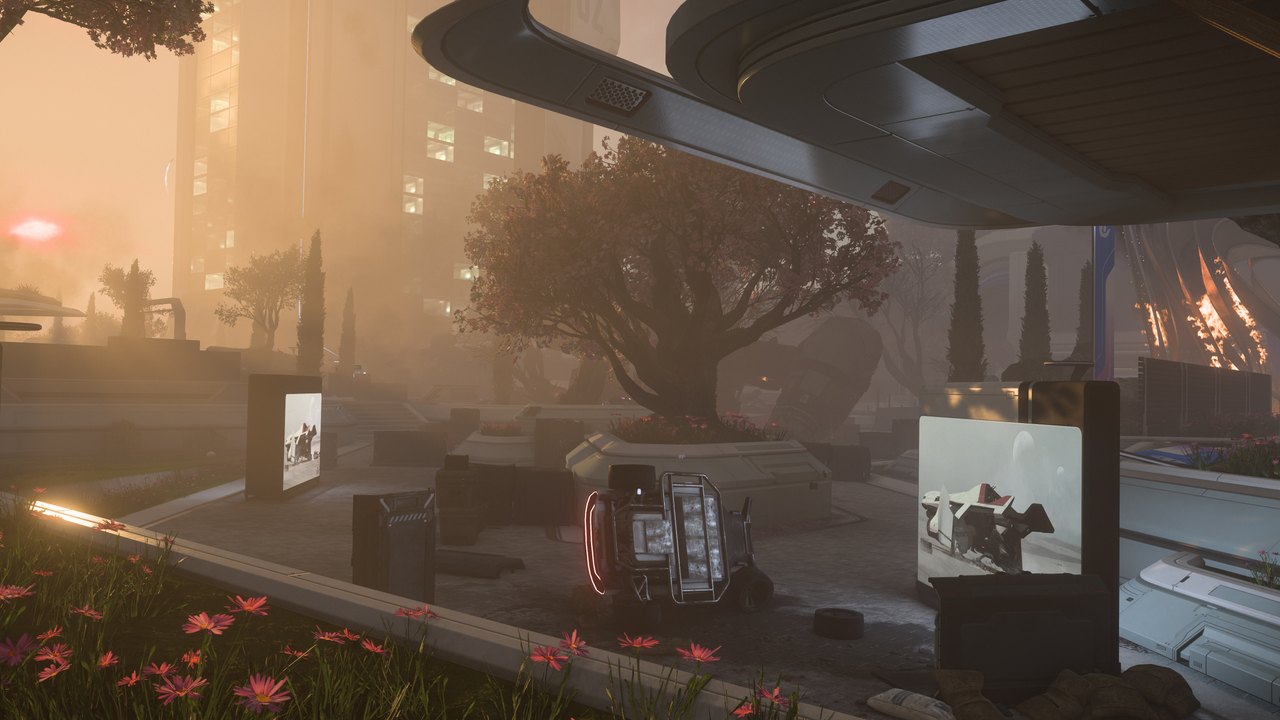 A battle damaged plaza in Orison at sunset, with a burning wreck and scattered barricades